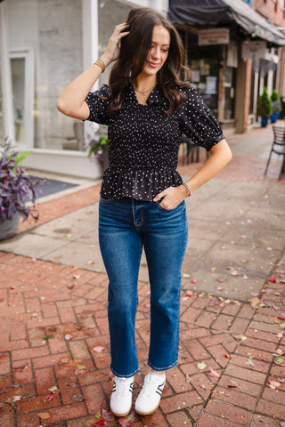 Black polka dot smocked blouse