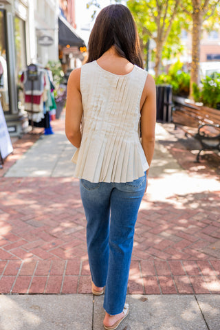 Sleeveless pleated front tie blouse
