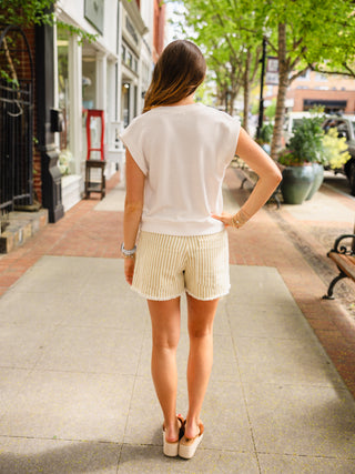 Braided belt, striped shorts