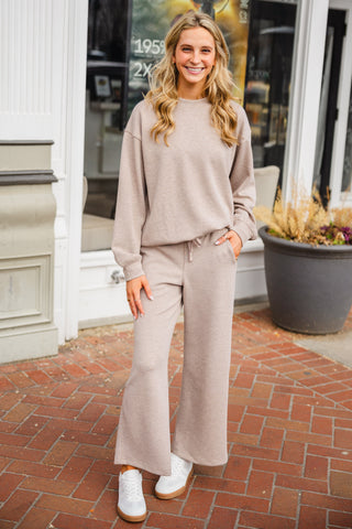 Woman wearing a beige matching top and bottom