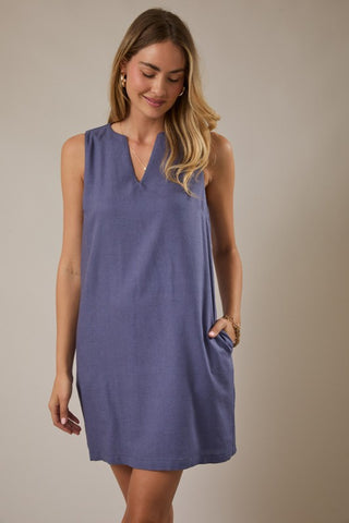Woman wearing a blue sleeveless dress