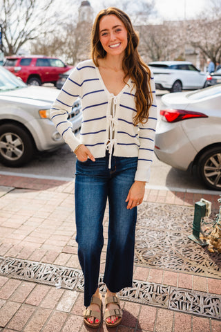 Woman wearing a striped cardigan and jeans