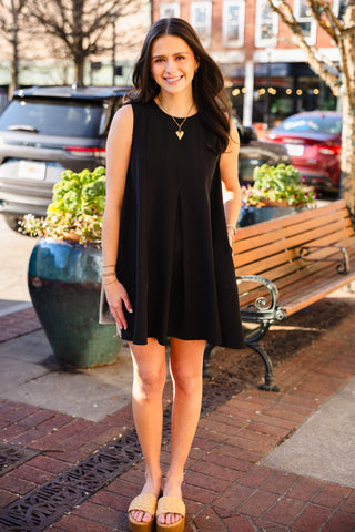 Black sleeveless pleated dress