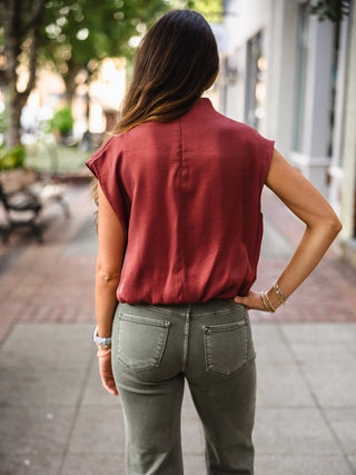 Rust mock neck bubble hem blouse