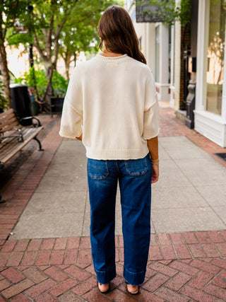 Exposed seam drop shoulder half sleeve sweater