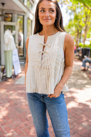 Sleeveless pleated front tie blouse