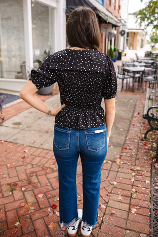 Black polka dot smocked blouse